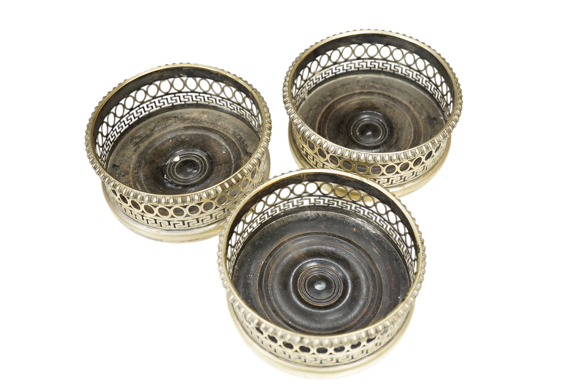 Three plated coasters, 13cm diameter